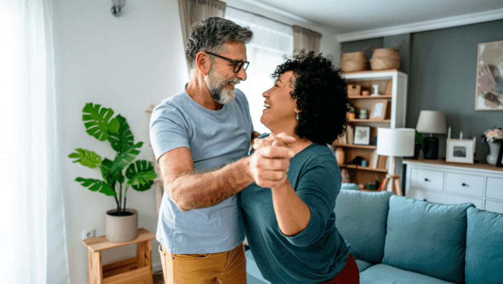 Couple in loungeroom dancing